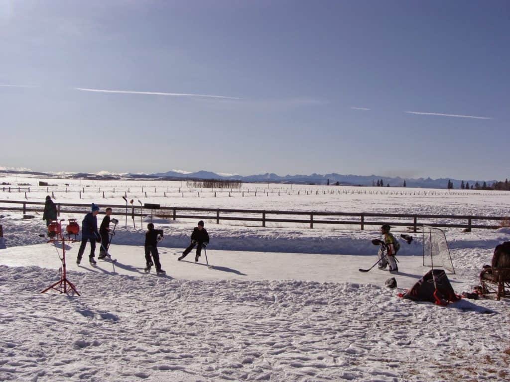 Kids Play Ice Hockey On A Homemade Outdoor Rink At Black Diamond Canada One Of The Best Small Towns In Alberta