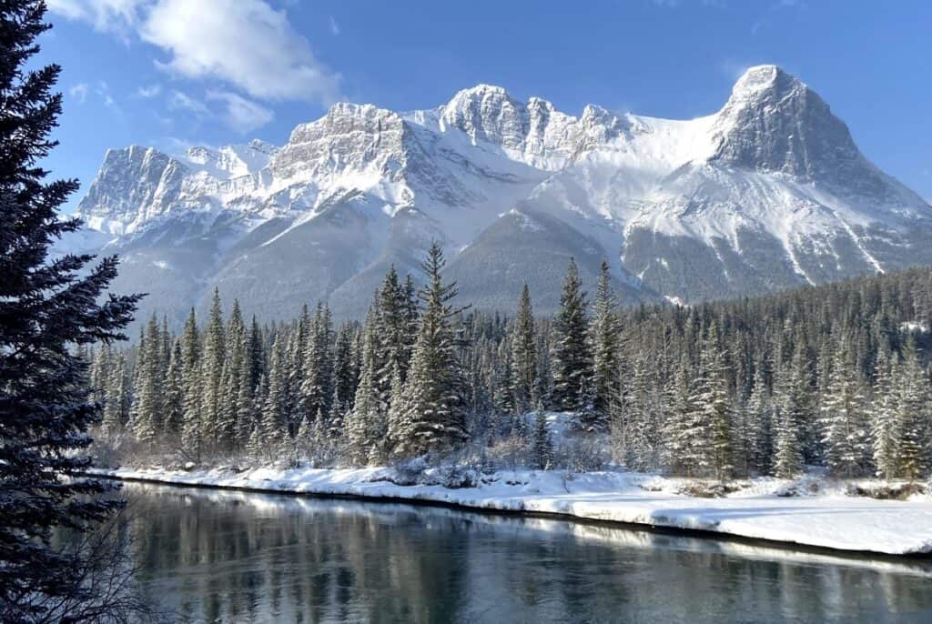 De superbes montagnes Rocheuses enneigées avec la rivière Bow au premier plan, l'une des meilleures raisons de déménager en Alberta Canada